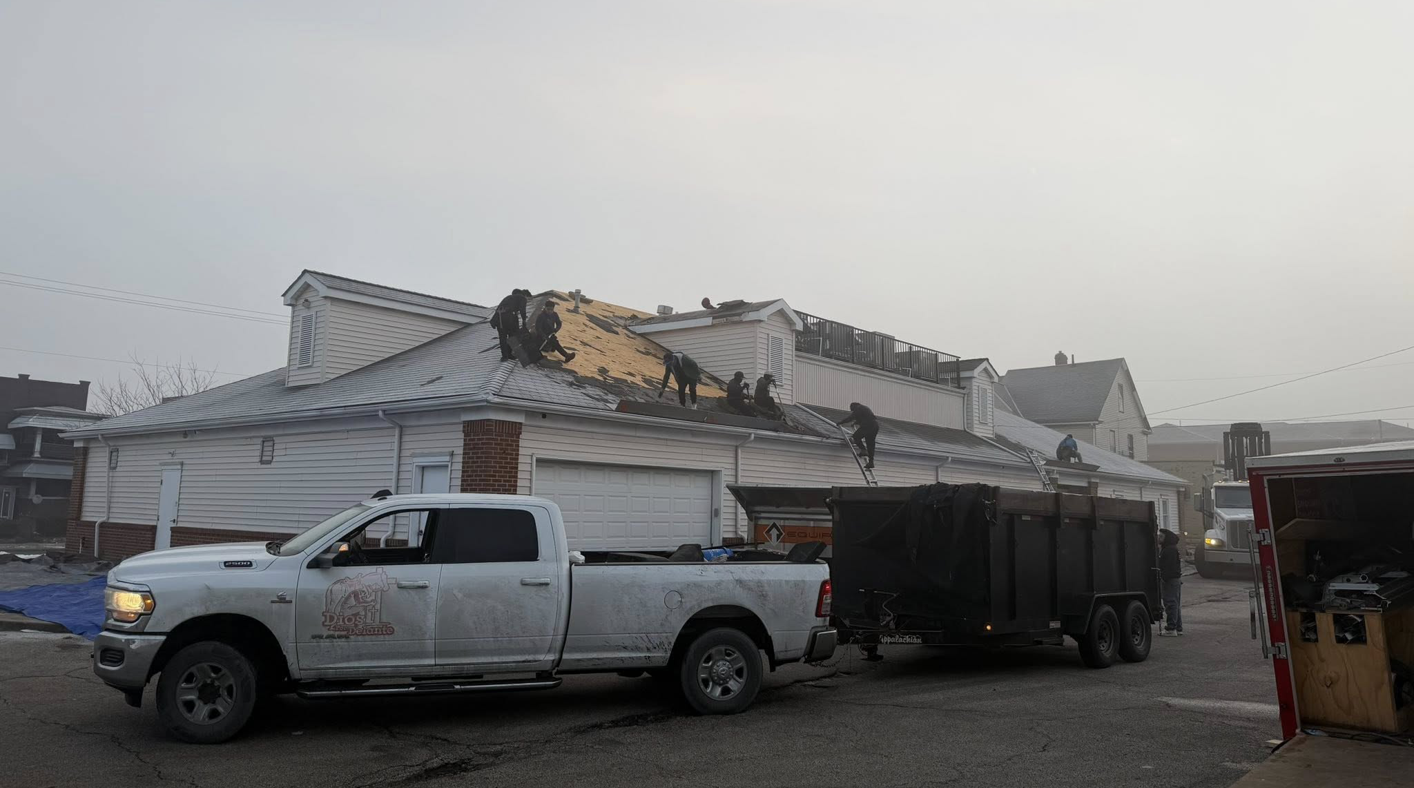J&K Roofing crew performing a full architectural shingle roof replacement