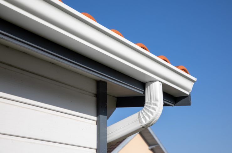 Seamless gutter installation crew working on a home exterior in Northeast Ohio