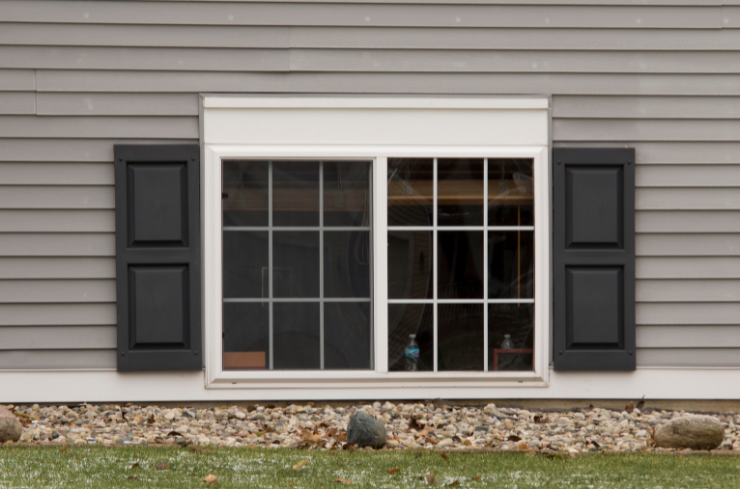 Vinyl replacement window installation crew at work on a Northeast Ohio home
